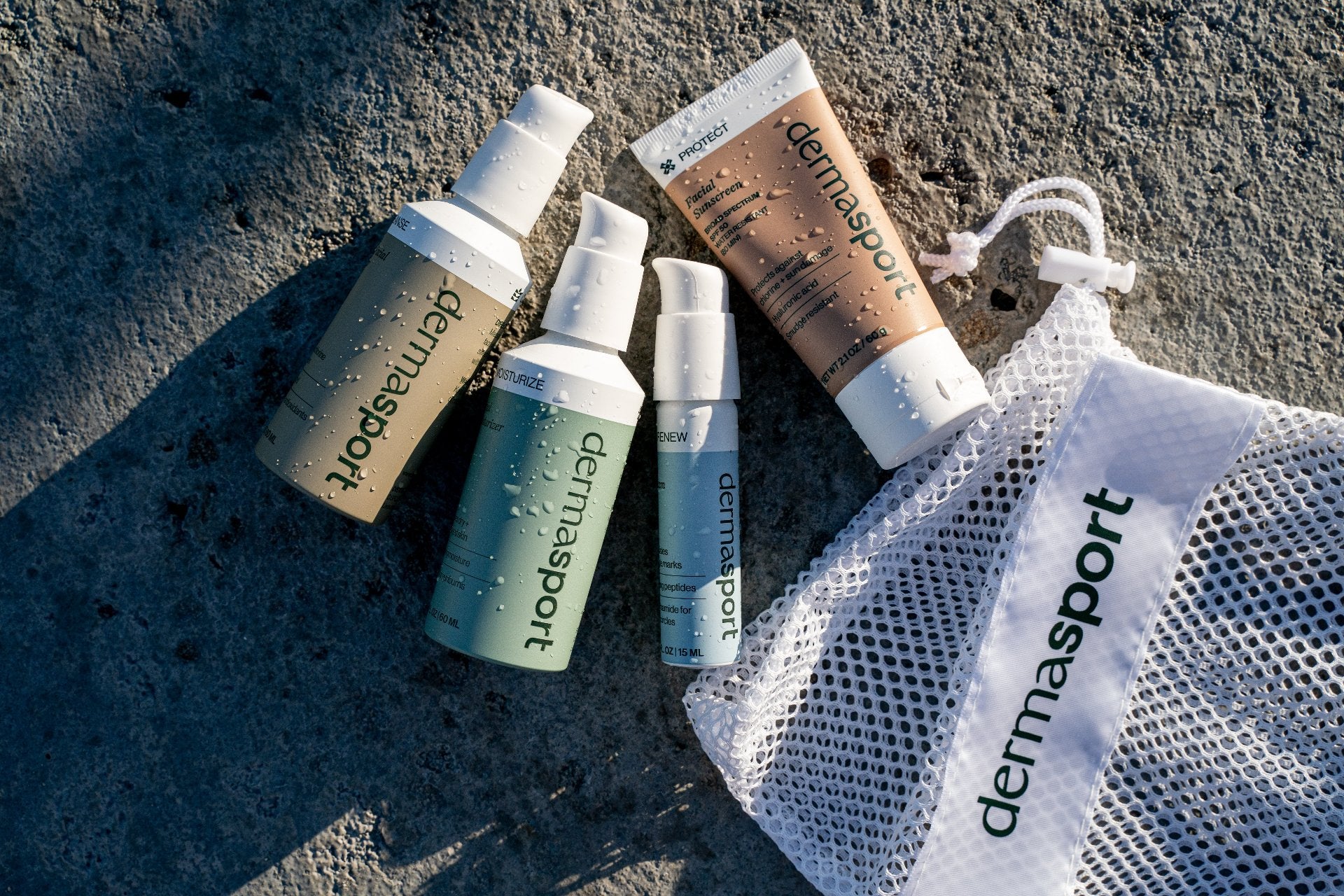 Hero image showcasing Dermasport's four products: SPF 50 Facial Sunscreen, Gentle Facial Cleanser, Facial Moisturizer, and Renew Eye Cream, designed for swimmers and athletes as part of a complete daily skincare system.
